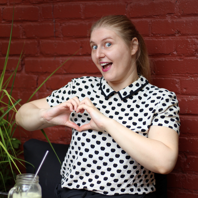 Myriam Jessier SEO trainer posing in front of a brick wall
